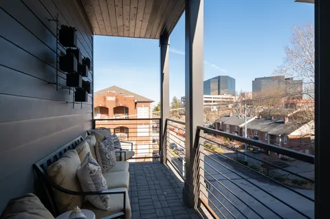 a living room with furniture and a floor to ceiling window