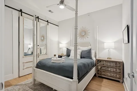 a bathroom with a granite countertop sink mirror vanity and toilet