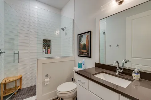 a bathroom with a toilet a sink and mirror