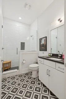 a bedroom with two beds and a dresser