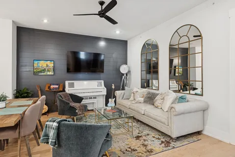 a kitchen with stainless steel appliances granite countertop a sink a stove a refrigerator dining table and chairs