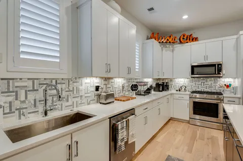 a view of a dining room with furniture and a chandelier