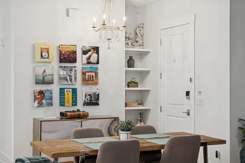 a living room with furniture a rug and a wall painting
