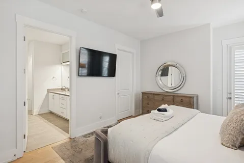 a spacious en suite bathroom with a double vanity sink and a mirror