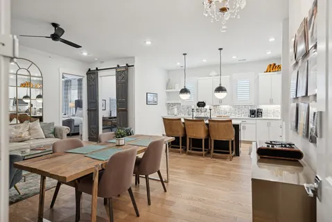 a large kitchen with a table and chairs