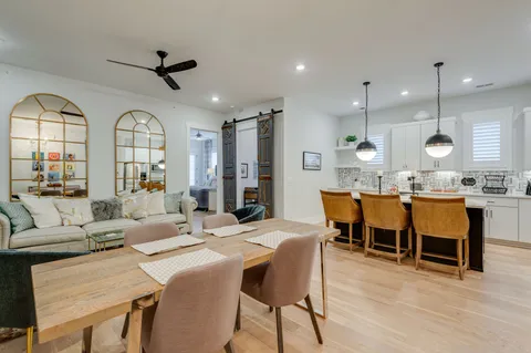 a view of a dining room with furniture and a chandelier