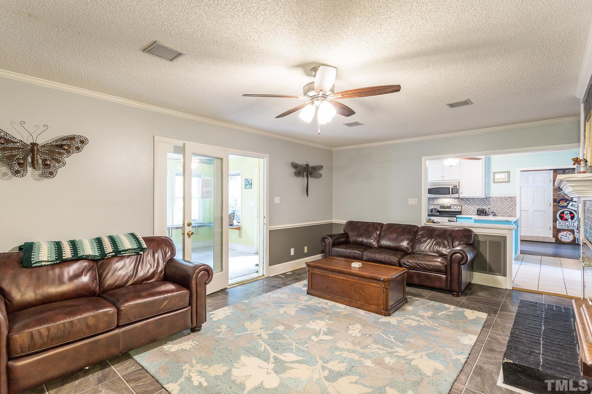 3213 Manor Ridge Drive Raleigh, NC 27603 - Photo 13 of 32 a living room with furniture ceiling fan and a window