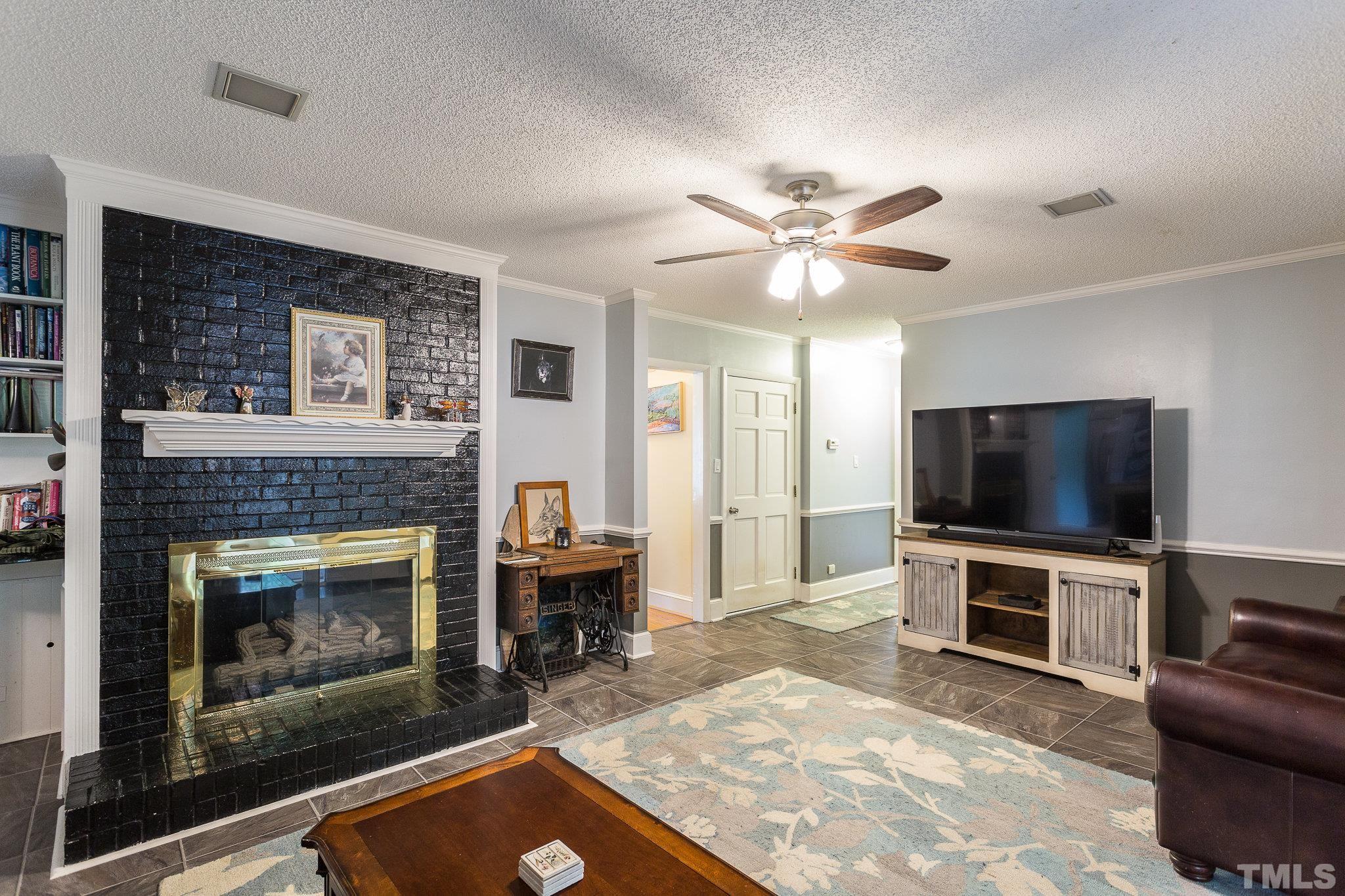 3213 Manor Ridge Drive Raleigh, NC 27603 - Photo 14 of 32 a living room with furniture and a fireplace