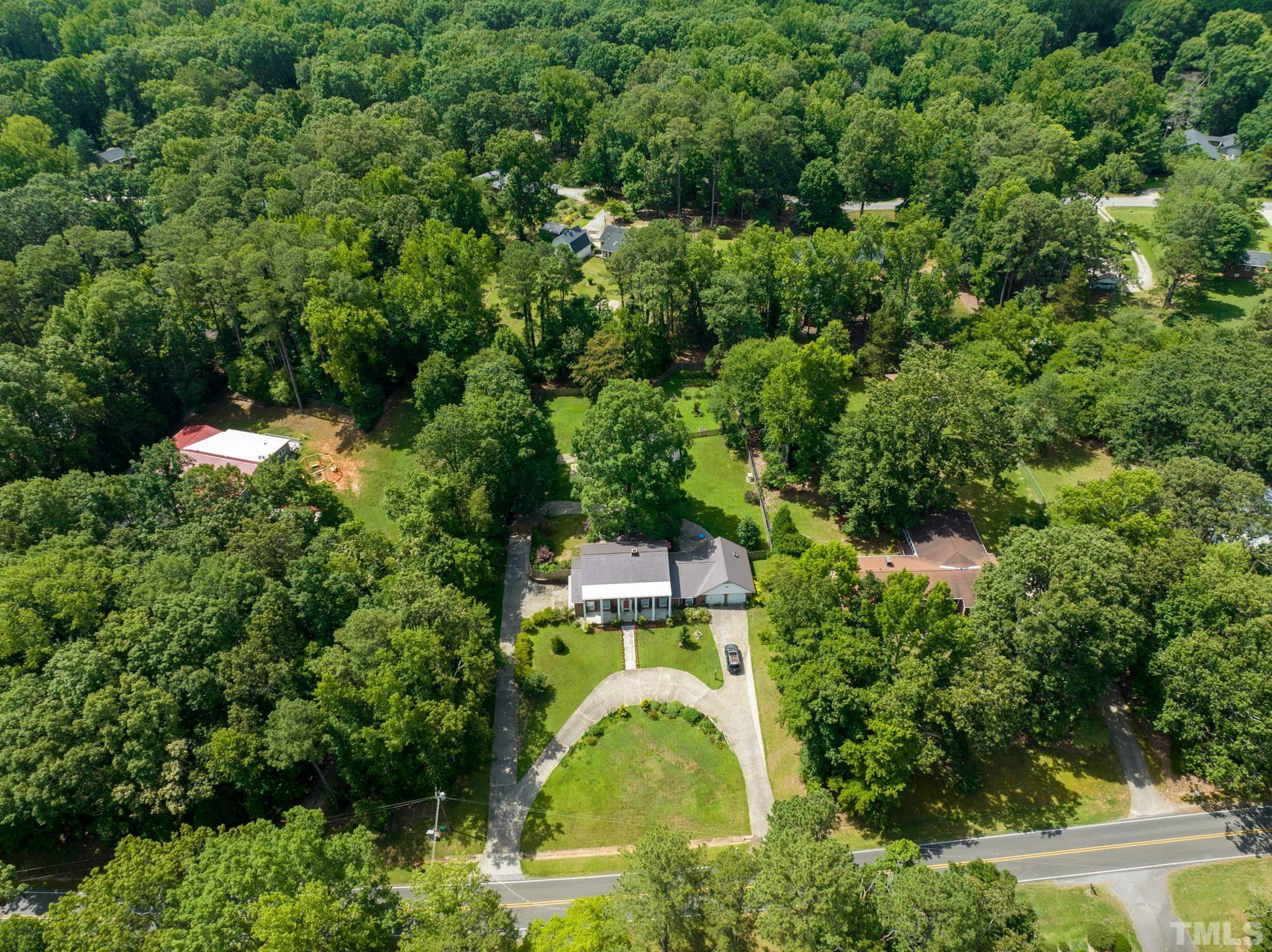 3213 Manor Ridge Drive Raleigh, NC 27603 - Photo 28 of 32 an aerial view of residential house with outdoor space and trees all around