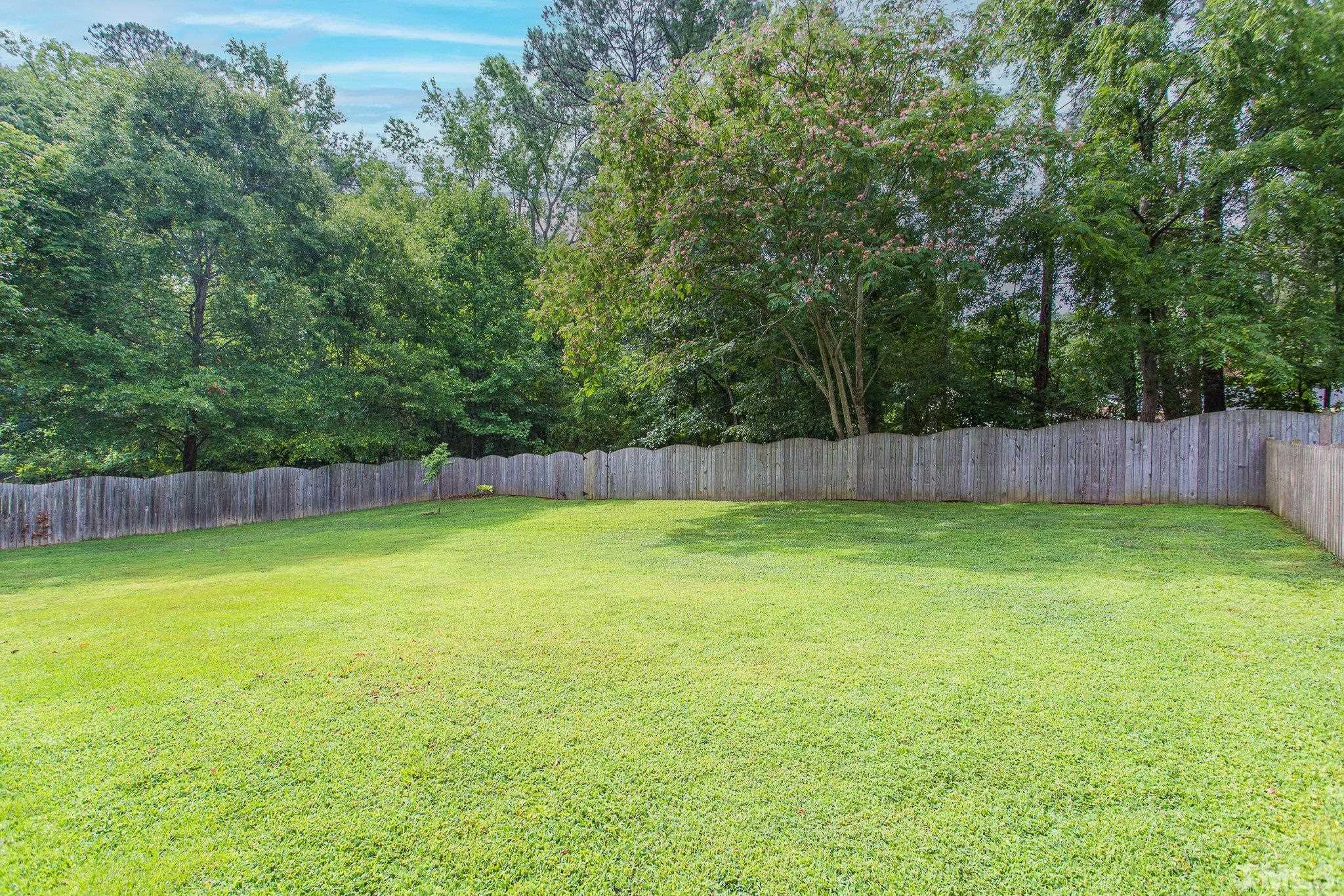 3213 Manor Ridge Drive Raleigh, NC 27603 - Photo 5 of 32 a view of a yard with a trampoline