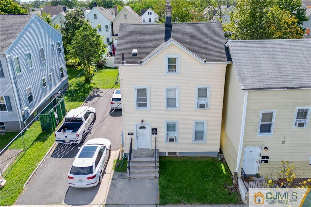 aerial view of multiple houses with yard