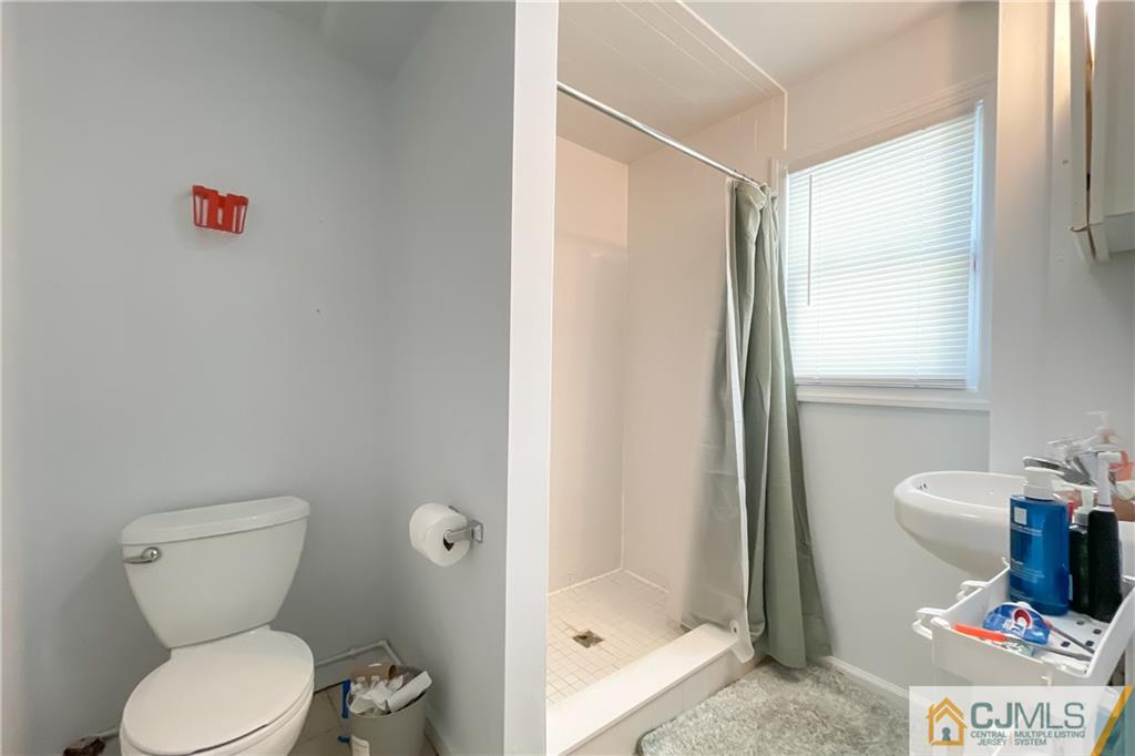 84 Guilden Street New Brunswick, NJ 08901 - Photo 11 of 27 a bathroom with a toilet and a shower
