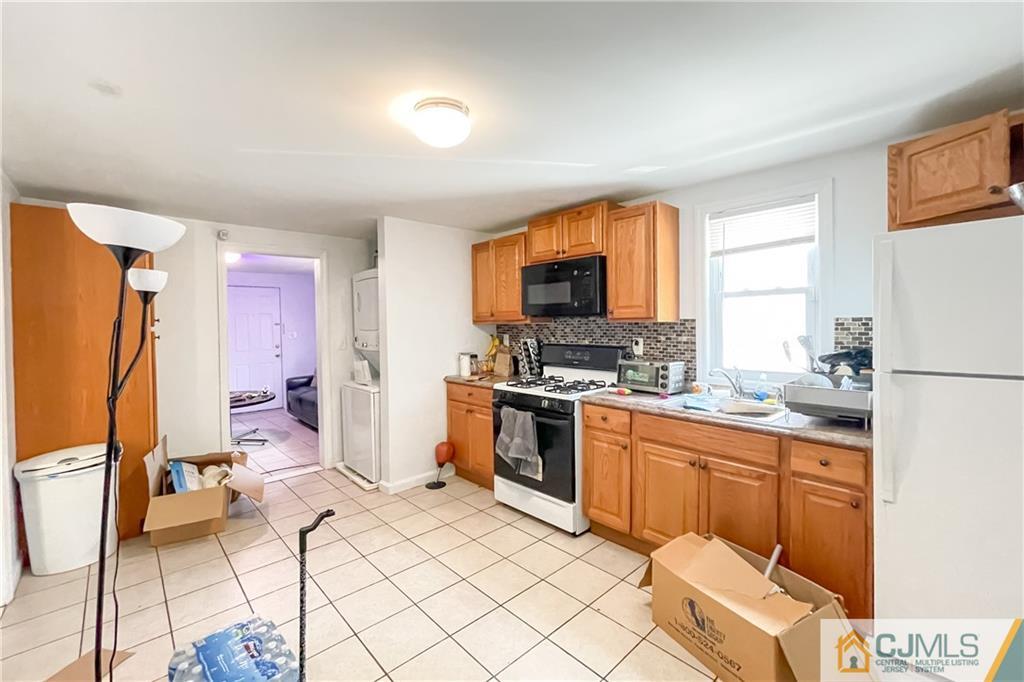 84 Guilden Street New Brunswick, NJ 08901 - Photo 12 of 27 a kitchen with a sink cabinets and appliances