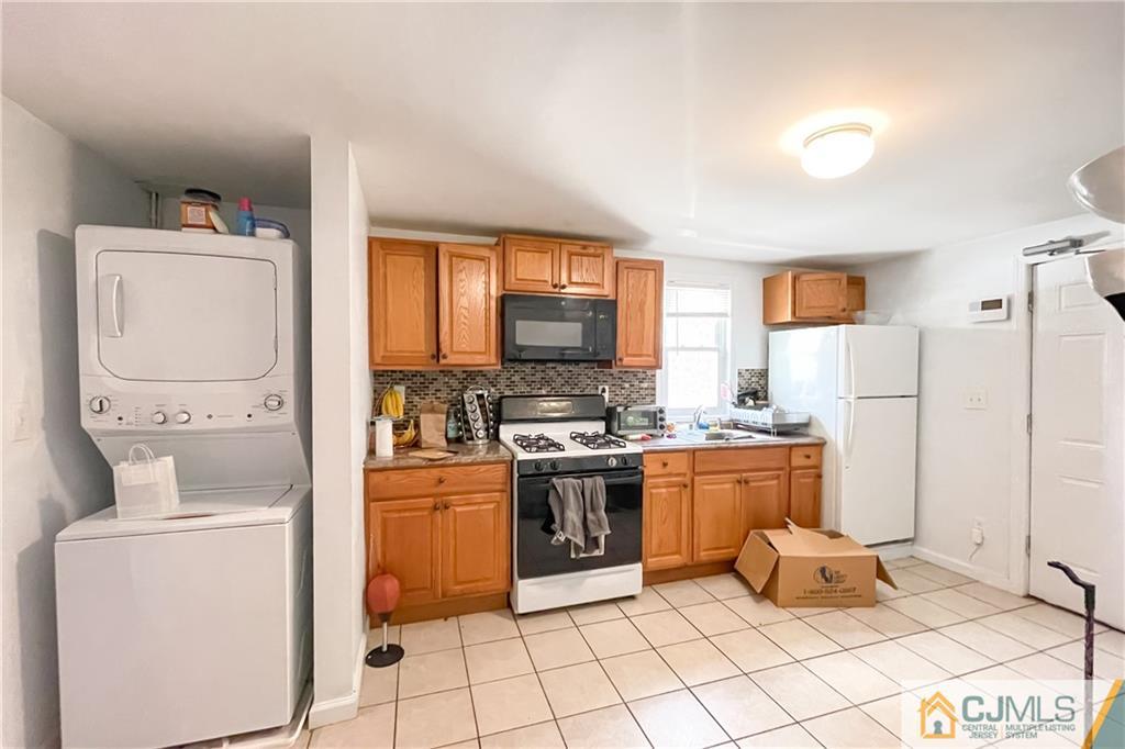 84 Guilden Street New Brunswick, NJ 08901 - Photo 13 of 27 a kitchen with a stove a sink and a refrigerator