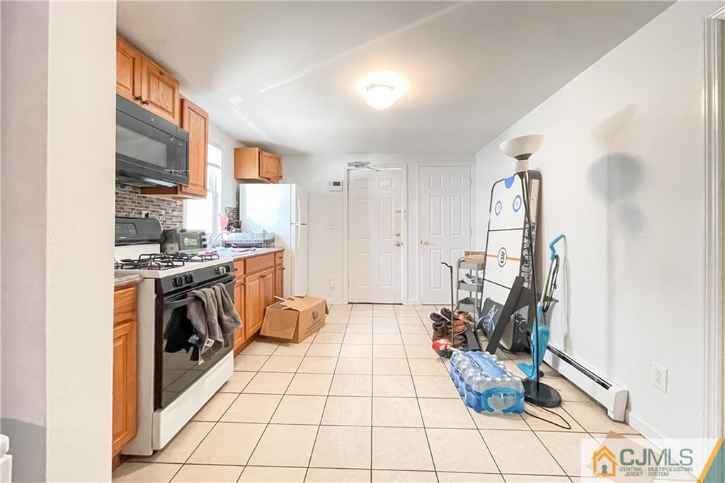84 Guilden Street New Brunswick, NJ 08901 - Photo 14 of 27 a kitchen with stainless steel appliances kitchen island granite countertop a stove a sink and a refrigerator