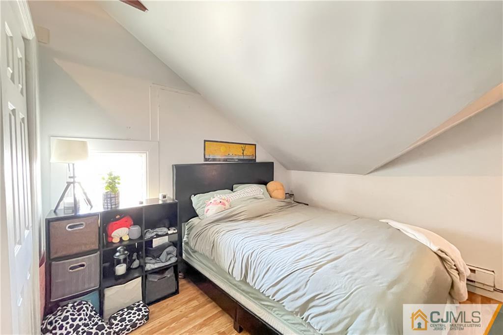 84 Guilden Street New Brunswick, NJ 08901 - Photo 20 of 27 a bedroom with a bed and a dresser