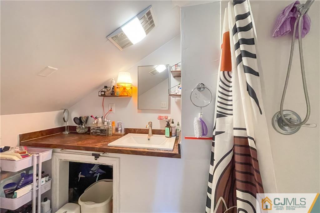 84 Guilden Street New Brunswick, NJ 08901 - Photo 22 of 27 a bathroom with a sink and a mirror