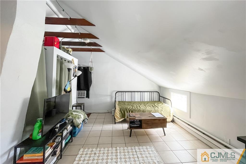 84 Guilden Street New Brunswick, NJ 08901 - Photo 23 of 27 a bedroom with a bed and a rug