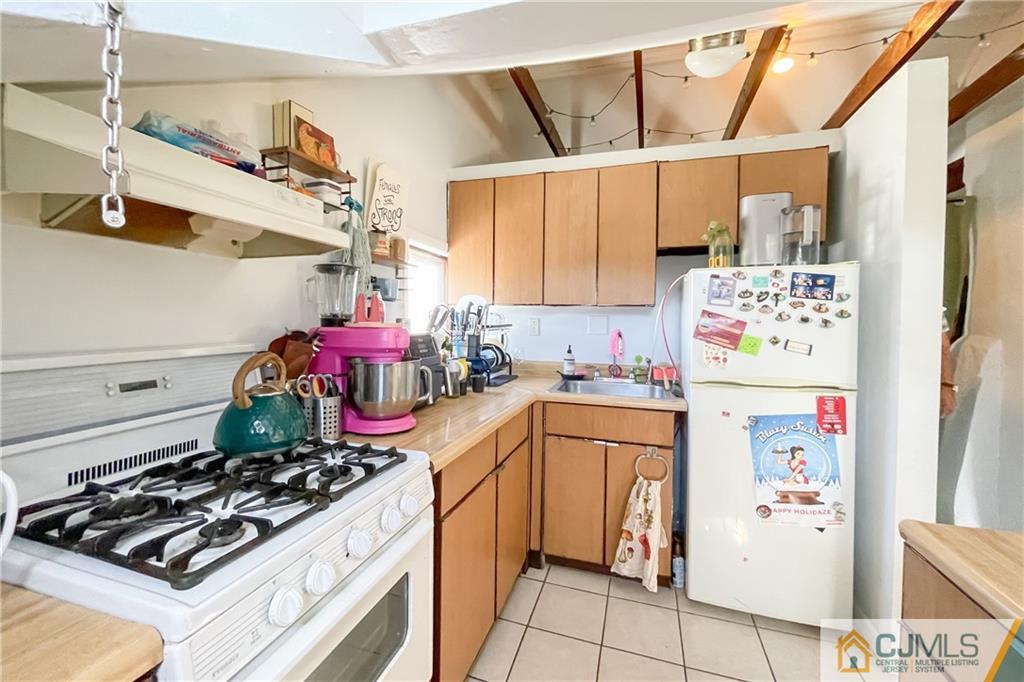 84 Guilden Street New Brunswick, NJ 08901 - Photo 25 of 27 a kitchen with stainless steel appliances a stove a refrigerator and a refrigerator