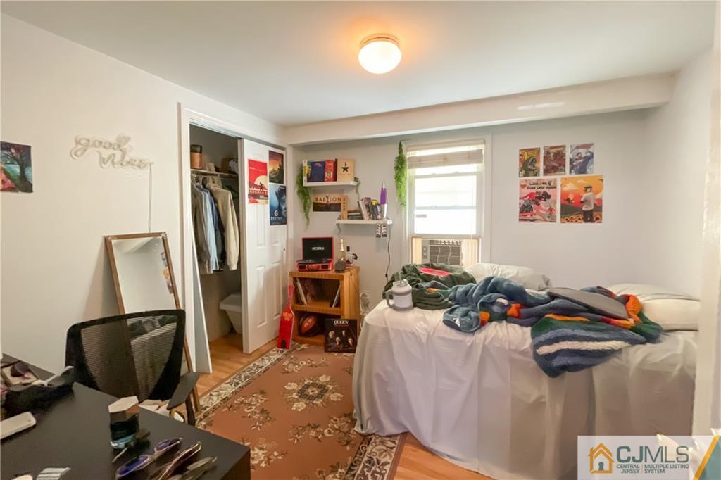 84 Guilden Street New Brunswick, NJ 08901 - Photo 6 of 27 a bed room with a bed and a chair