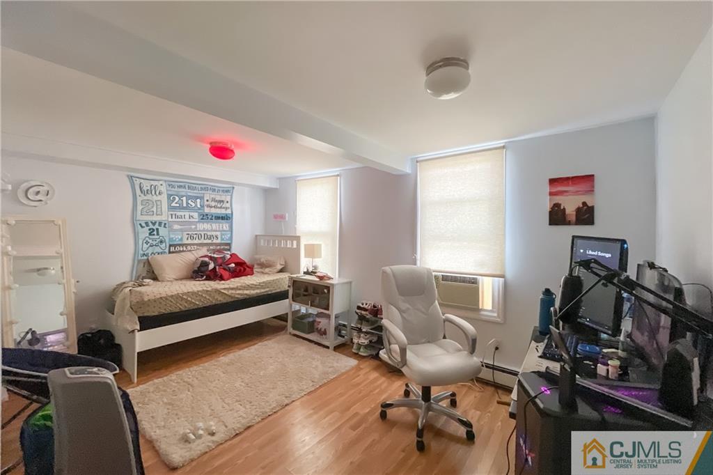 84 Guilden Street New Brunswick, NJ 08901 - Photo 7 of 27 a bedroom with furniture and a window