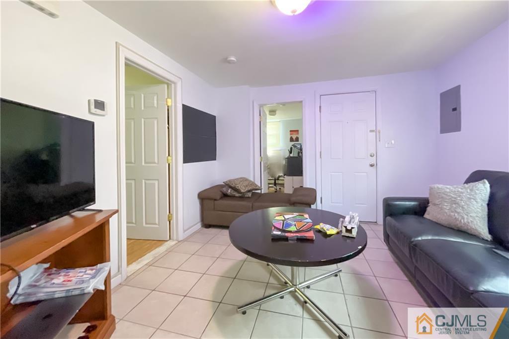84 Guilden Street New Brunswick, NJ 08901 - Photo 9 of 27 a living room with furniture and a flat screen tv