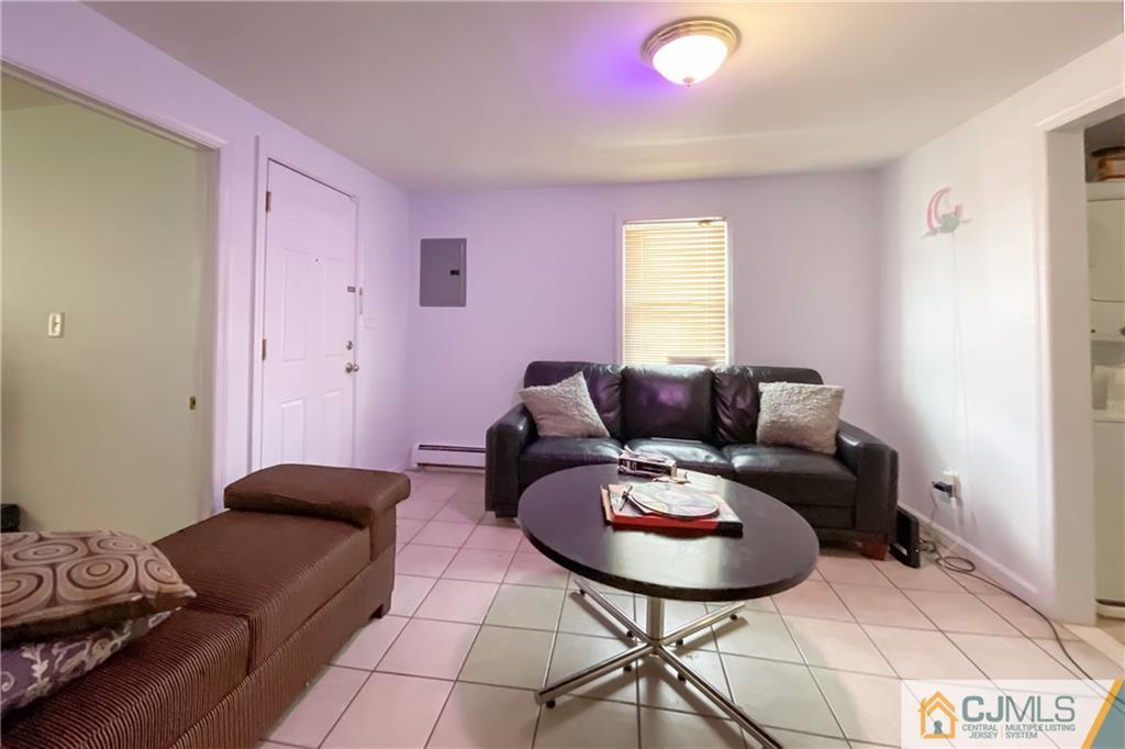 84 Guilden Street New Brunswick, NJ 08901 - Photo 10 of 27 a living room with furniture and a window