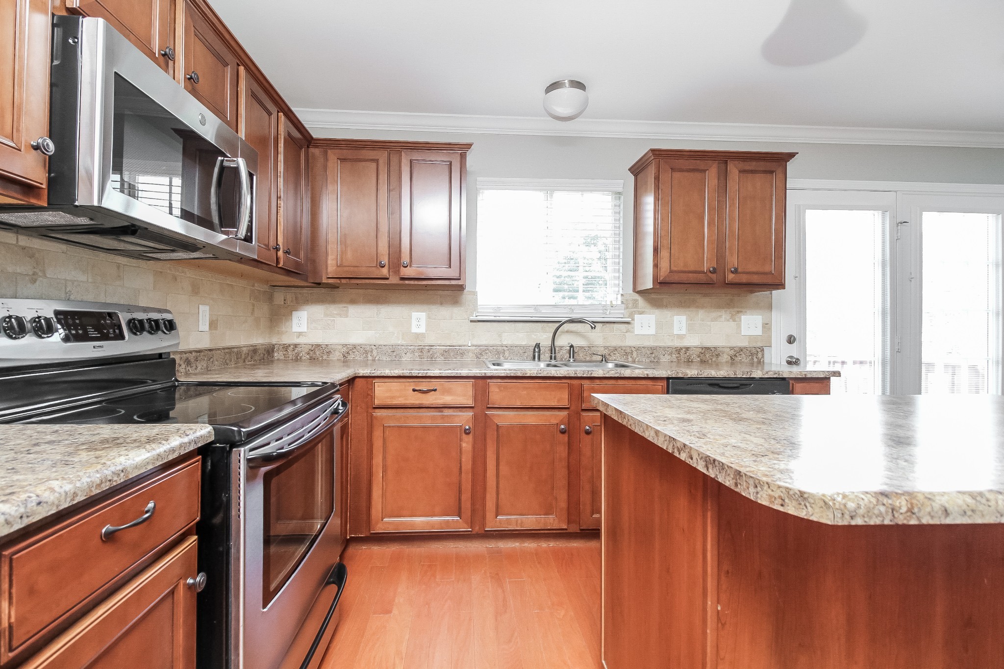 1129 Matheus Drive Murfreesboro, TN 37128 - Photo 4 of 17 a kitchen with granite countertop stainless steel appliances and wooden cabinets