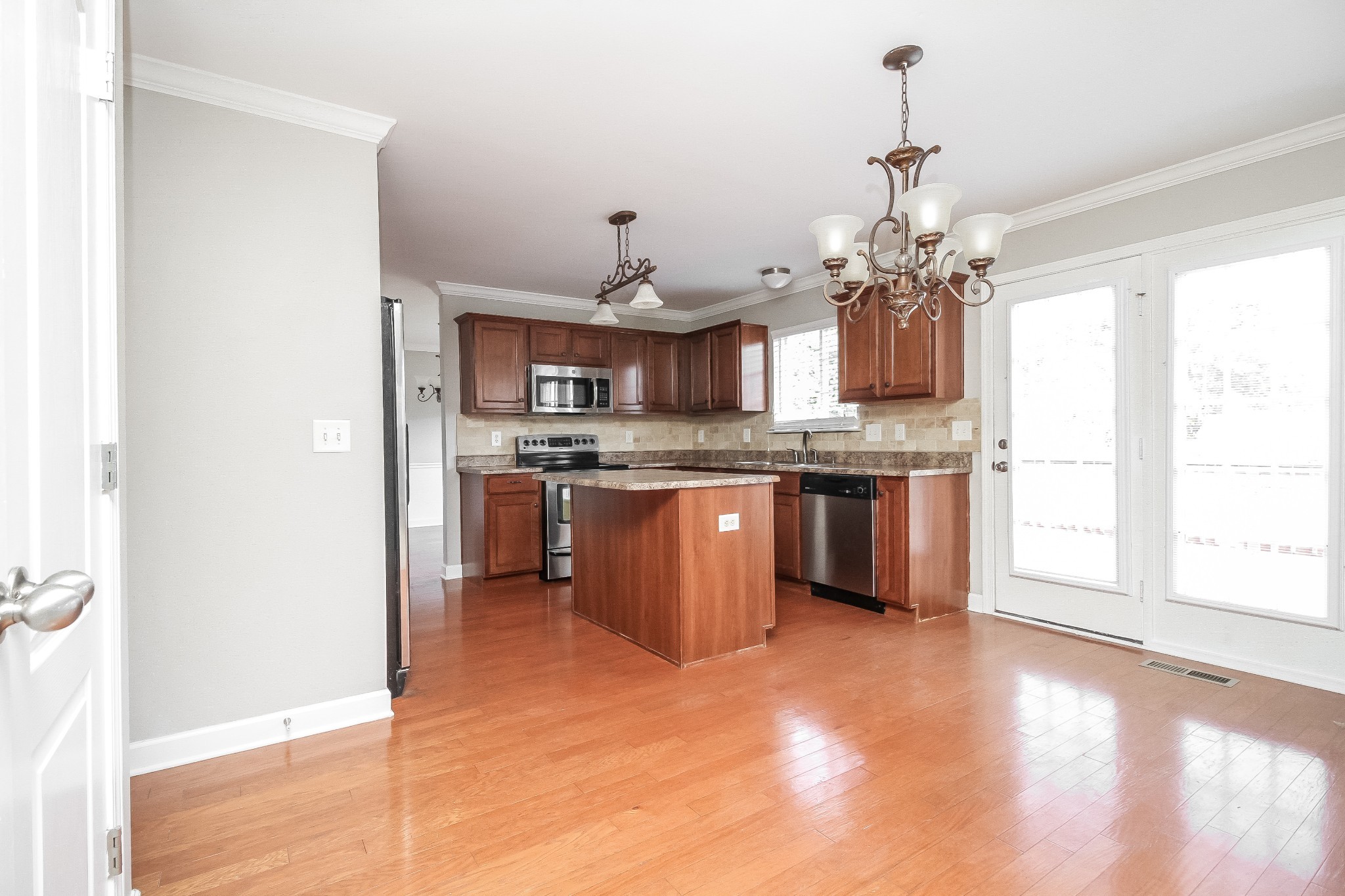 1129 Matheus Drive Murfreesboro, TN 37128 - Photo 6 of 17 a kitchen with kitchen island a sink a stove and a window