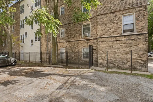 a view of a brick house with many windows
