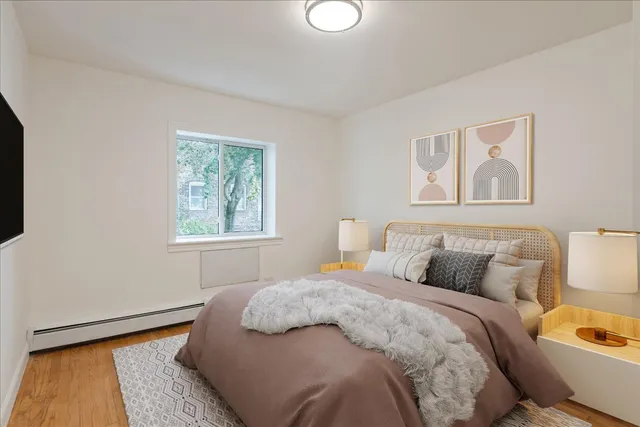 a bedroom with a bed and a window