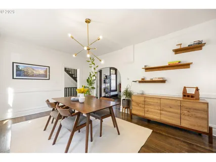 a kitchen with a table chairs and cabinets