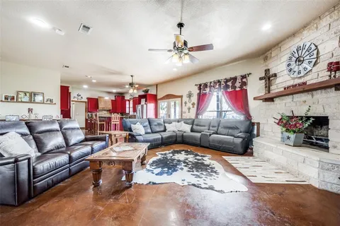 a living room with furniture kitchen area and a couch