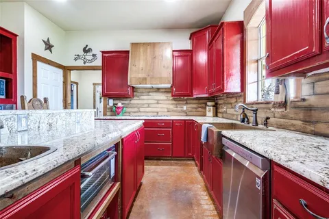 a kitchen with stainless steel appliances granite countertop a sink stove and cabinets