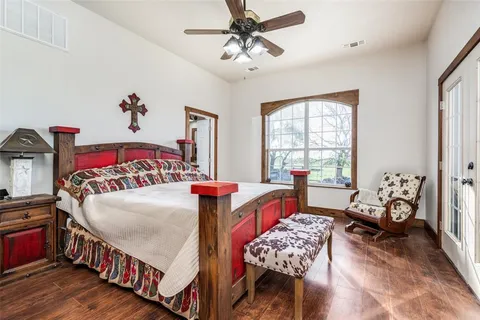 a bedroom with a bed and a chandelier