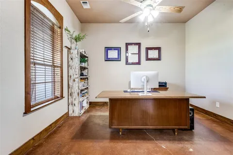 a view of workspace with window and hallway