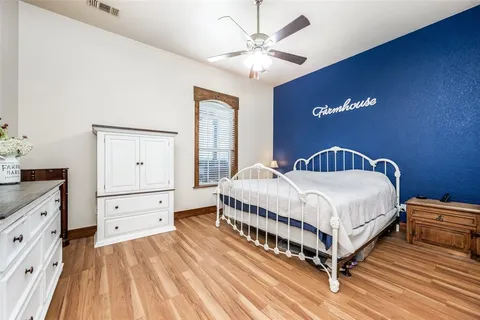 a spacious bedroom with a bed and a chandelier