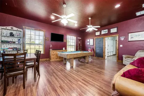a living room with furniture a flat screen tv and a large window
