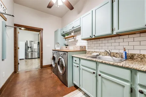 a utility room with sink dryer and washer