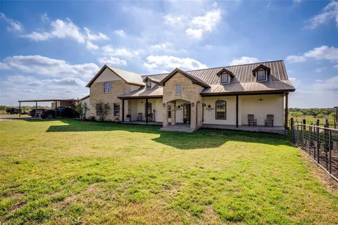 a front view of a house with swimming pool having outdoor seating
