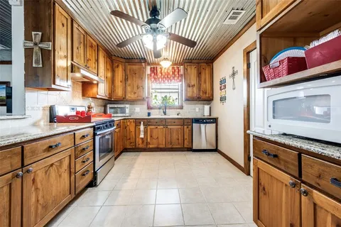 a kitchen with stainless steel appliances granite countertop a sink and cabinets