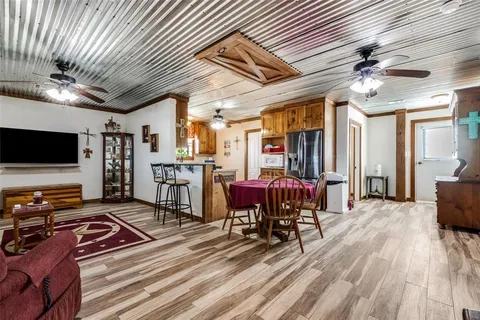 a living room with lots of furniture and flat screen tv