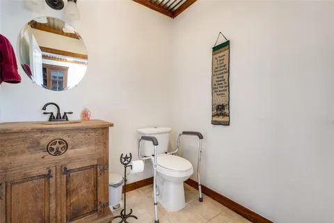 a bathroom with a toilet a sink and mirror