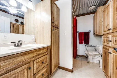 a bathroom with a sink a toilet and a mirror