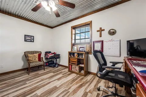 a bedroom with furniture a rug and wooden floor