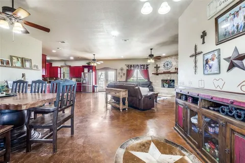 a living room with lots of furniture and kitchen view