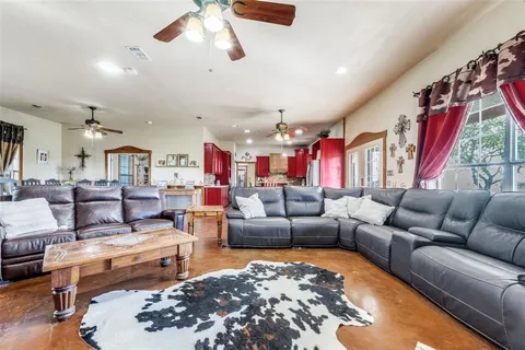 a living room with furniture ceiling fan and rug