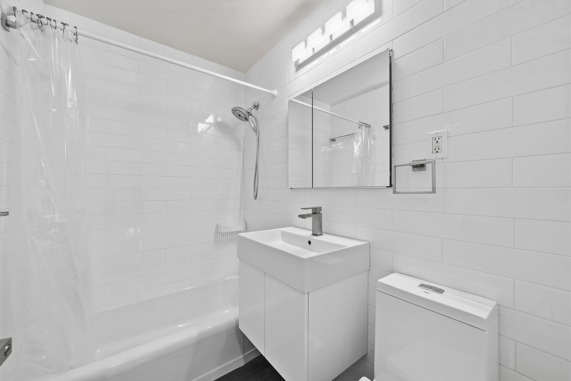 340 East 80th Street, Unit 17D Manhattan, NY 10075 - Photo 11 of 18 a bathroom with a sink a toilet and shower