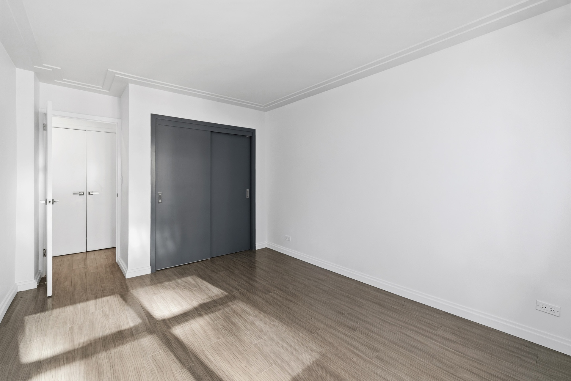 340 East 80th Street, Unit 17D Manhattan, NY 10075 - Photo 14 of 18 an empty room with wooden floor and closet