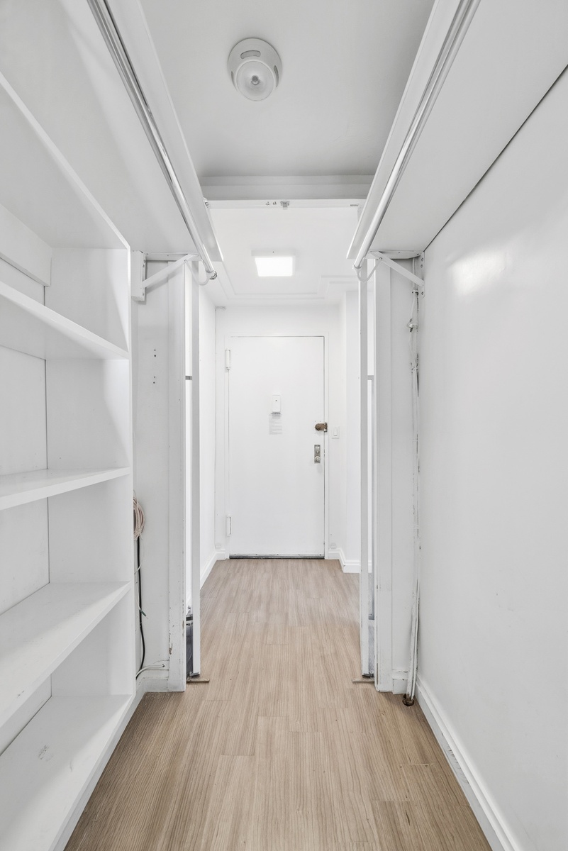 340 East 80th Street, Unit 17D Manhattan, NY 10075 - Photo 16 of 18 a view of hallway with a large window and wooden floor